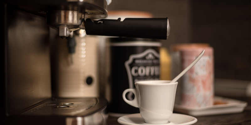 Coffee bar with an espresso machine and mug.
