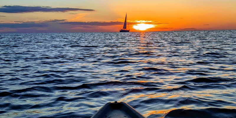 Sailboat from a Kayak at Sunset
