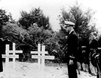 Black and white image of sailors commemorating gravestones in Ocracoke.