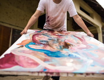 Under the Oaks Arts Festival Focus in on canvas with different paint swirls.