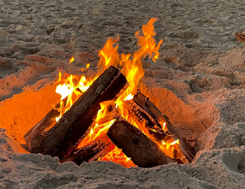 Outer Banks Beach Fires - Teaser Image of logs burning on a beach.