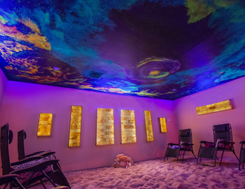 Pink and purple cave with a pink salt floor and galaxy painted ceiling.