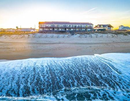 Condo complex on the oceanfront at sunset - A Great Escape
