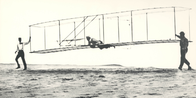 Image of Wright Brothers flying airplane on OBX.