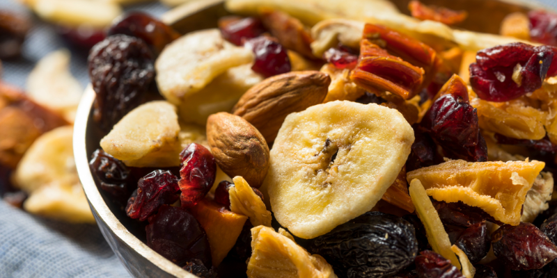 Image of trail mix with almonds and dried fruit in a bowl; Beach Snacks - Trail Mix