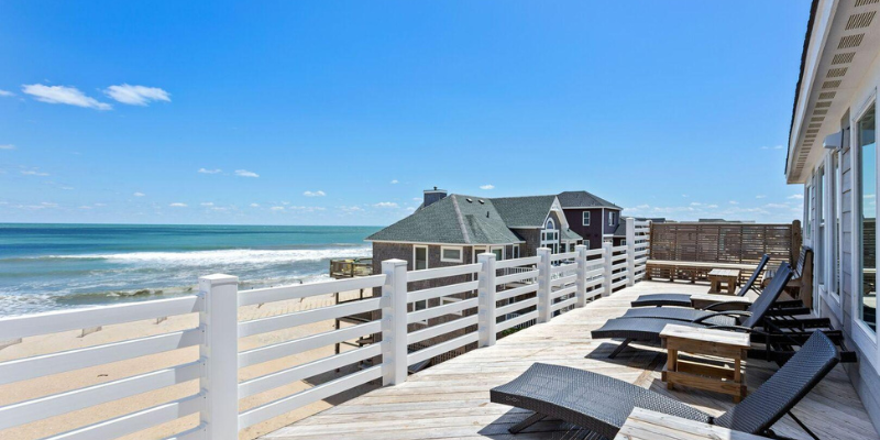 Top sun deck of beach house overlooking the ocean.