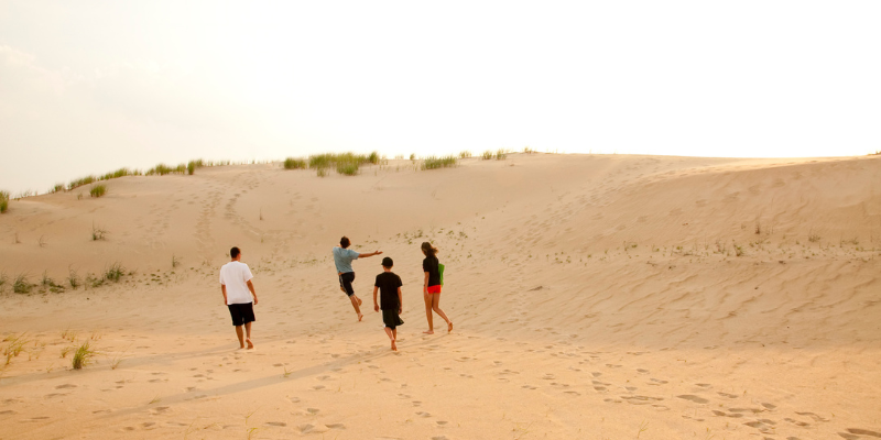 Family walking on the sand dunes.