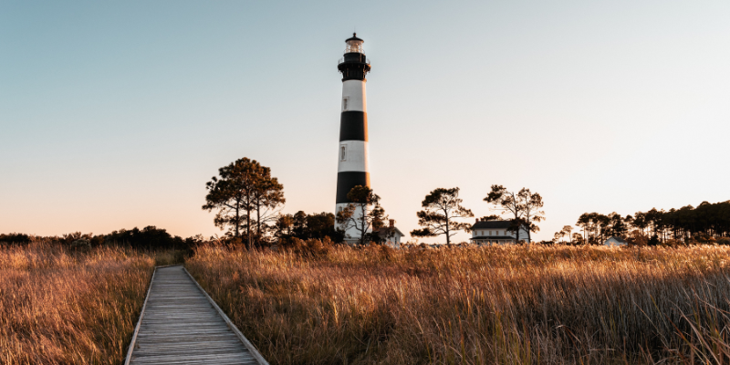 Image of sunset behind Bodie Island Lighthouse in Nags Head.