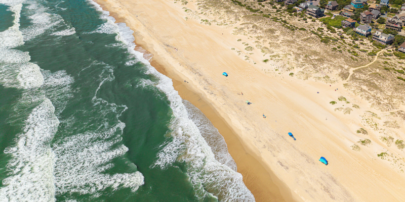 Beach Access Points Wide beach access with ocean waves.