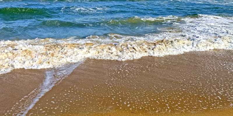 Waves breaking on beach.