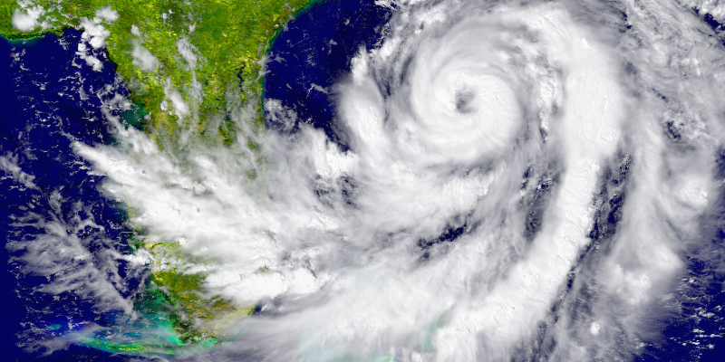 Overhead image of a hurricane crossing the state of Florida near the Atlantic Ocean.