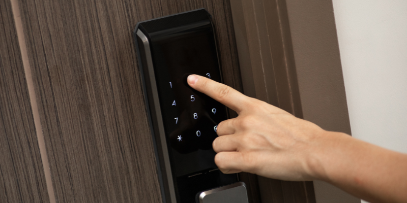 Finger pressing numbers on a keypad.