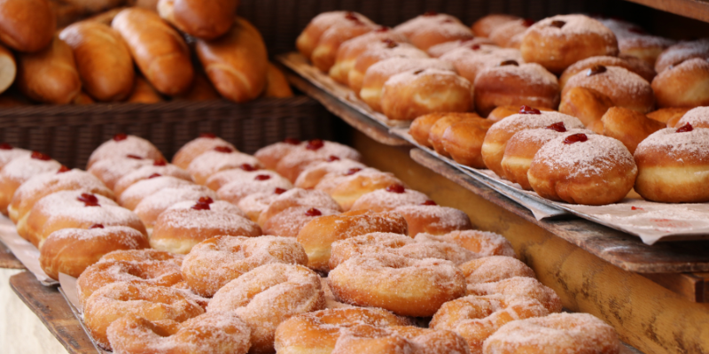 Image of jelly donuts in bakery.