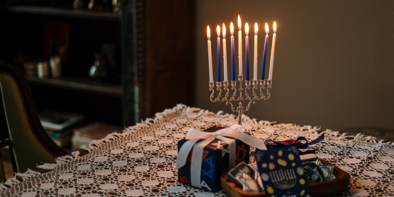 Image of menorah and Hanukkah fits on table.
