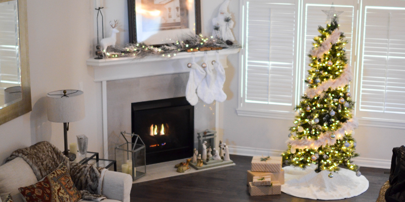 Image of living room with Christmas tree and fireplace.