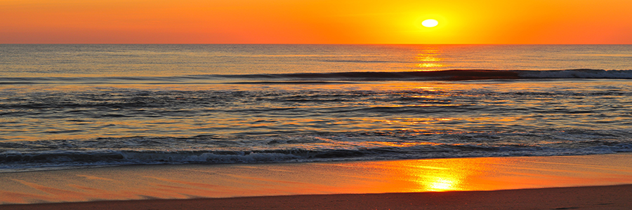 Bright orange sunset over the ocean.