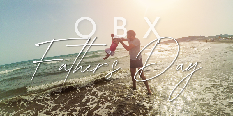 Father and child playing in the ocean.