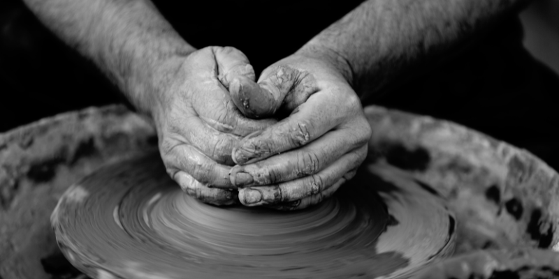 Local Handmade OBX Art - Image of hands working on pottery wheel, black and white