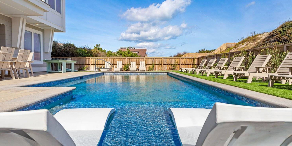Summer Pool Days View of a swimming pool on a summer day at an Outer Banks vacation rental.